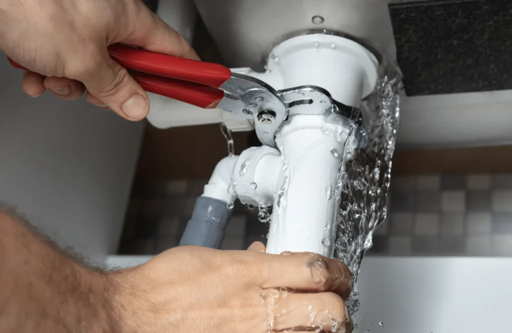 Licensed plumber in Weston FL using advanced equipment to detect hidden water leaks and repair damaged pipes inside a home